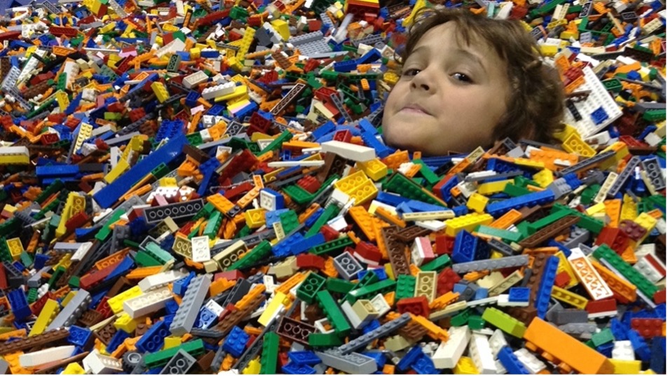 Child in sea of Legos