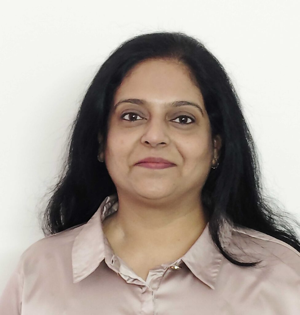 headshot photo of smiling woman with long straight black hair parted in the middle
